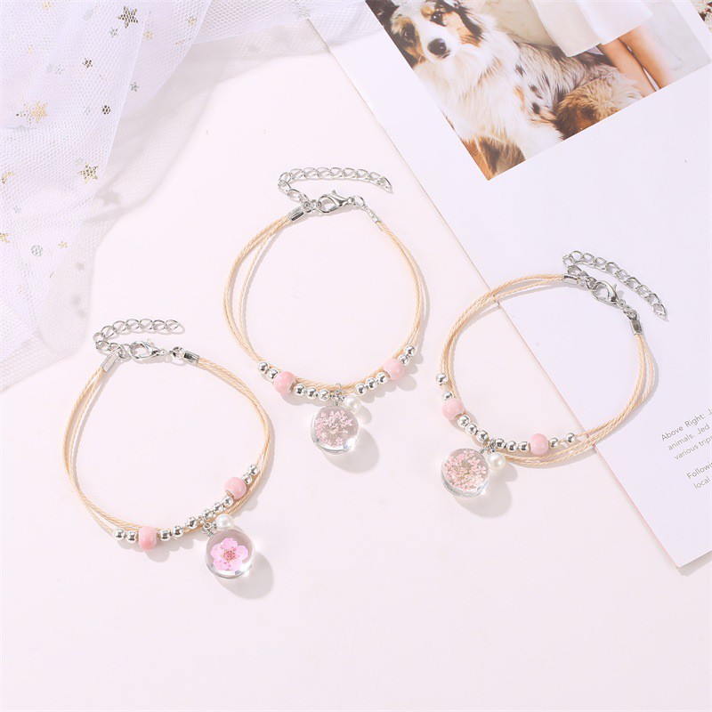 The aqua sphere shaped accessory bracelet contains lovely Korean style dried flowers