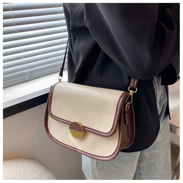 Túi xách nữ đeo chéo khóa tròn kiểu dáng yên ngựa thanh lịch có hai màu trắng và đen