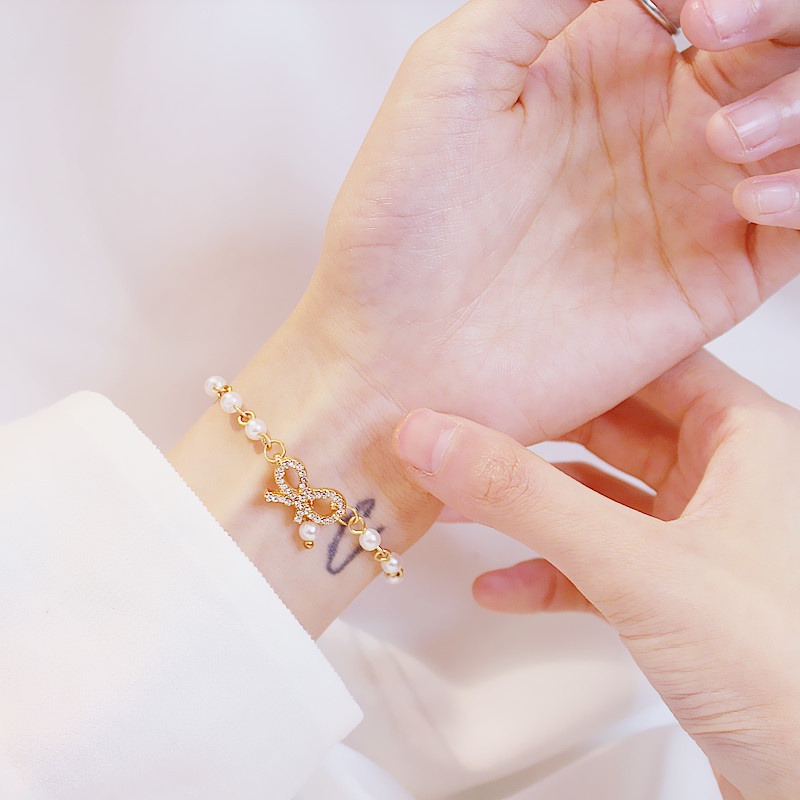 Vòng Tay Chuỗi Hạt Ngọc Trai Mặt Hình Nơ Đính Pha Lê Phong Cách Hàn Quốc Ngọt Ngào Cho Nữ