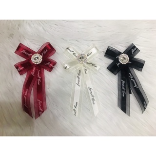 Cài áo nơ voan phối chữ. kt 9x17cm