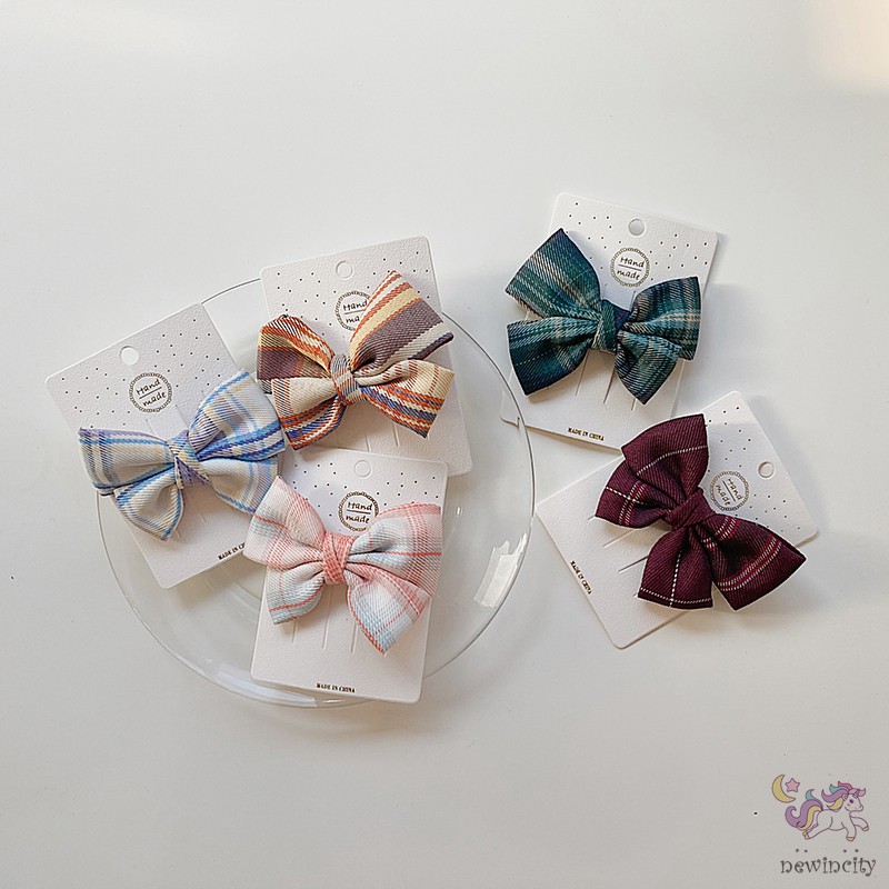 Kẹp tóc đính nơ kẻ sọc ca rô xinh xắn dành cho bé gái