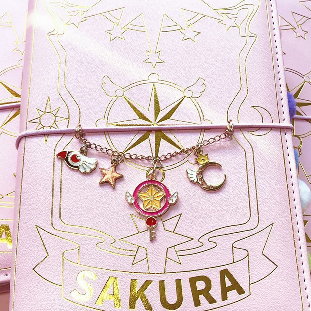 Sổ tay khổ A6 màu hồng in hình phong cách anime Sakura Thủ Lĩnh thẻ Bài Nhật Bản chất lượng cao