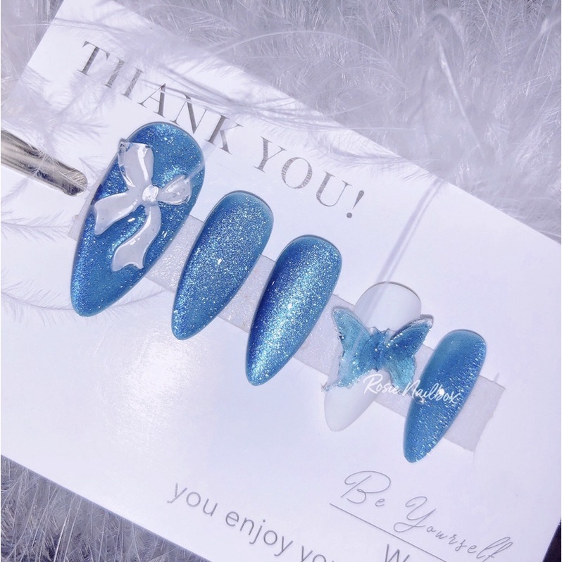 Móng giả mắt mèo xanh dương lung linh phối nơ xinh xắn cho nàng