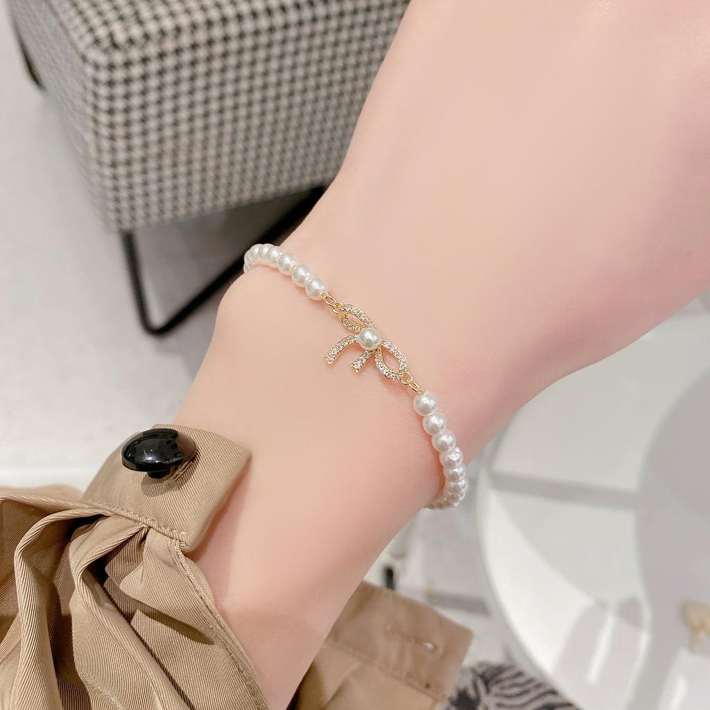 Vòng đeo tay AHELLOGIRL chuỗi hạt ngọc trai đính nơ thiết kế tinh tế thời trang cho nữ