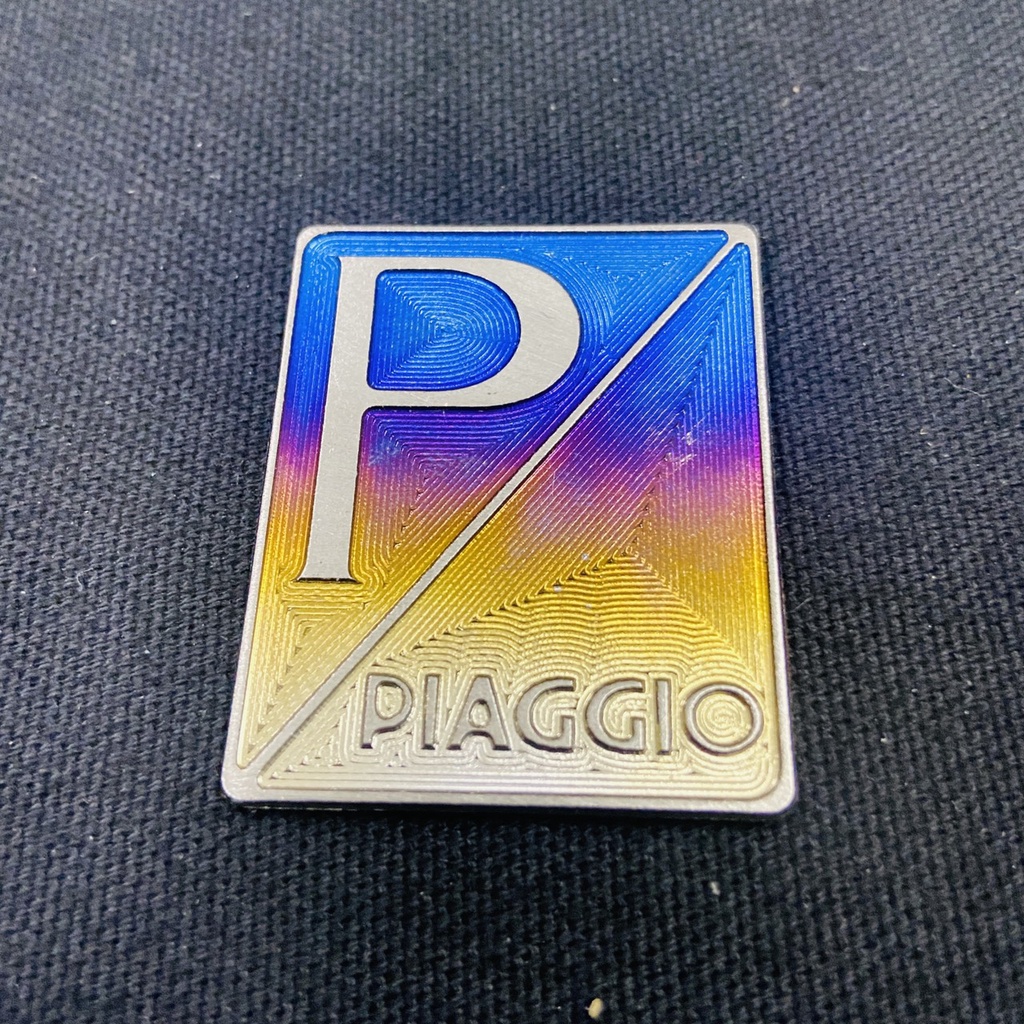Logo titan tem dán mặt nạ xe VESPA PIAGGO chất liệu titan gr5 ( có sẳn keo 3mm )