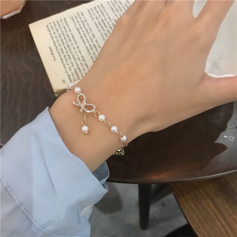Vòng Tay Chuỗi Hạt Ngọc Trai Mặt Hình Nơ Đính Pha Lê Phong Cách Hàn Quốc Ngọt Ngào Cho Nữ