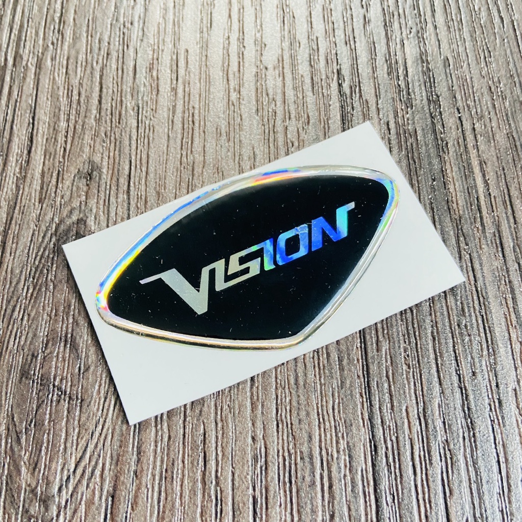 (TEM VISION) TEM LOGO VISION, tem phủ nhựa trong chữ VISION 2 màu lựa chọn
