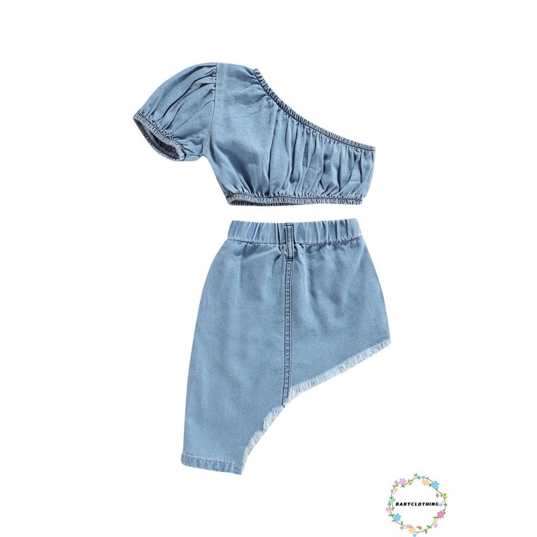 Set áo kiểu croptop denim tay ngắn hở một bên vai và chân váy denim vạt lệch màu sắc thời trang dành cho bé gái