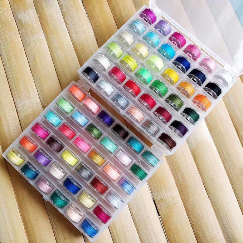 Hộp đựng suốt 25 ngăn gồm 25 con suốt và chỉ như hình