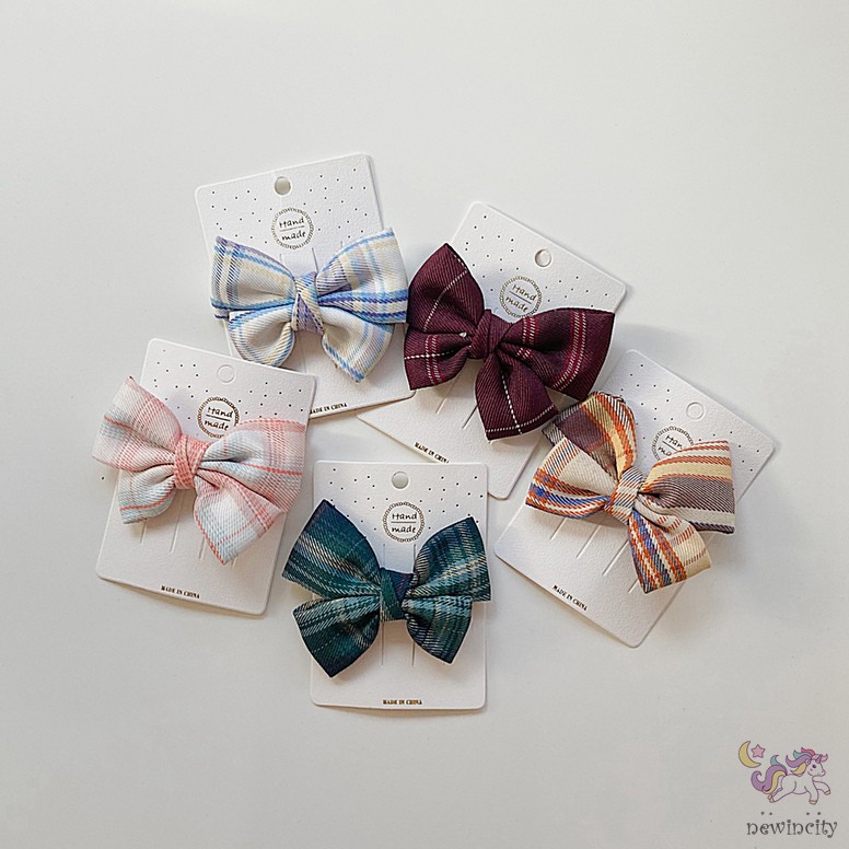 Kẹp tóc đính nơ kẻ sọc ca rô xinh xắn dành cho bé gái