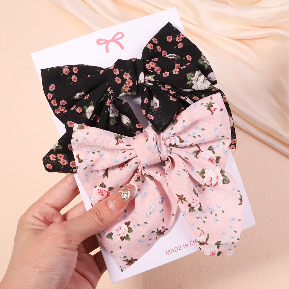 Set 2 kẹp tóc KIDSBOWS hình nơ họa tiết hoa xinh xắn dành cho nữ