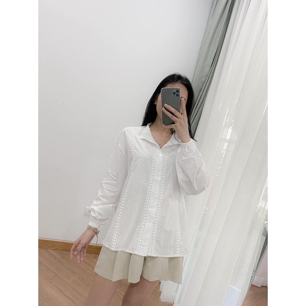 Áo sơ mi trắng cổ tàu tay bo chun.