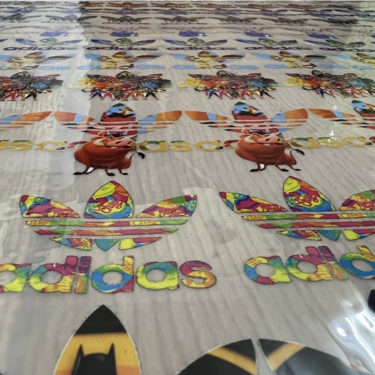 - Logo Adidas nhiều màu in trực tiếp lên vải bằng bàn ủi, bàn là
