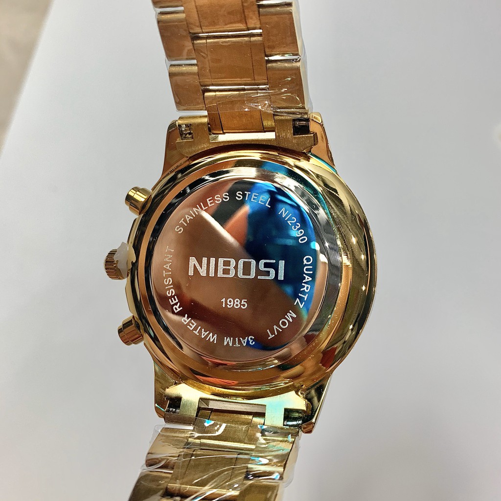 Đồng Hồ Nam NIBOSI NI2390 Dây Thép Cao Cấp Chạy 6 Kim - Tặng Pin Dự Phòng Và Cây Tháo Mắc (Dây Vàng, Mặt Đen)