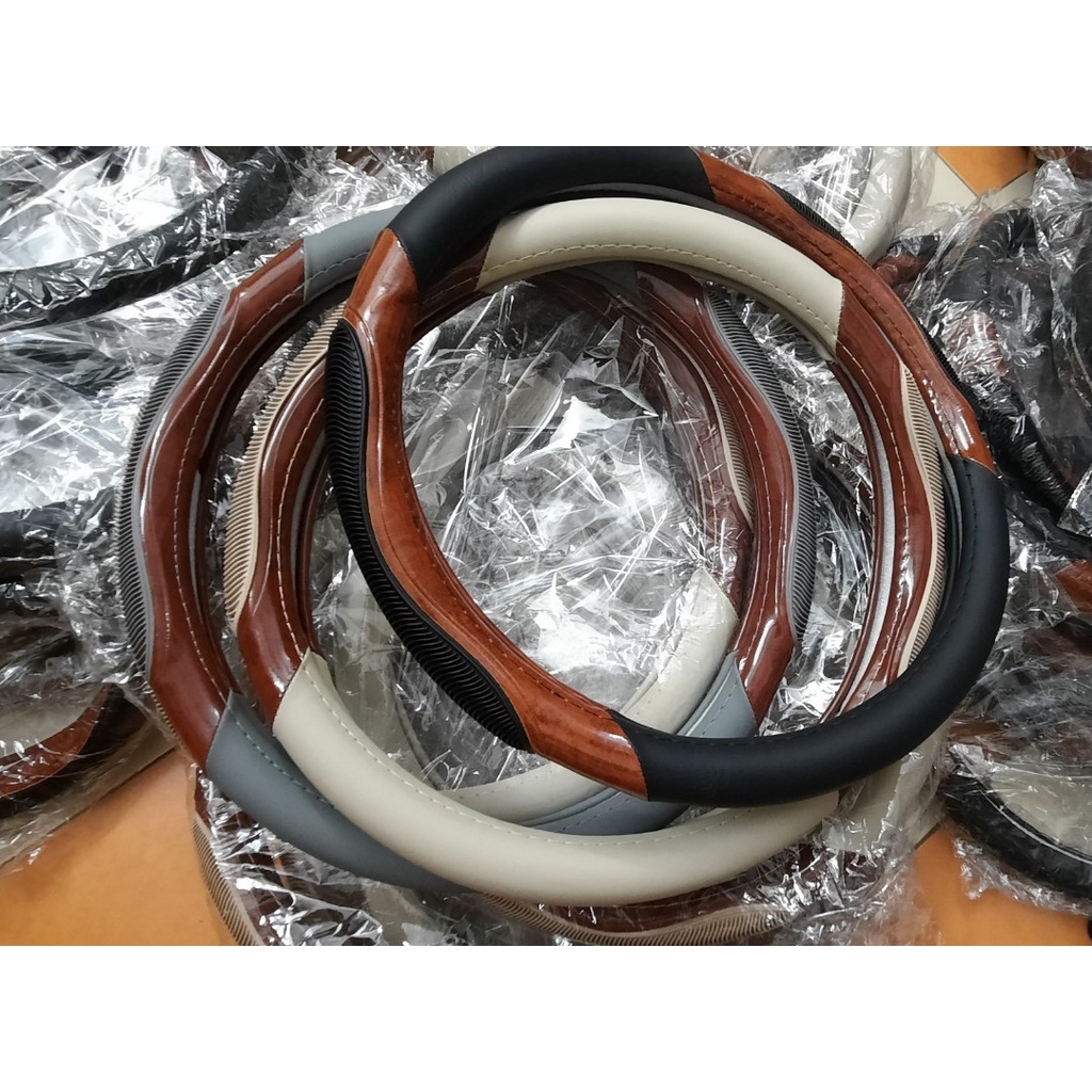 Bọc volang oto, bao tay lái xe hơi da vân gỗ pha gân massage