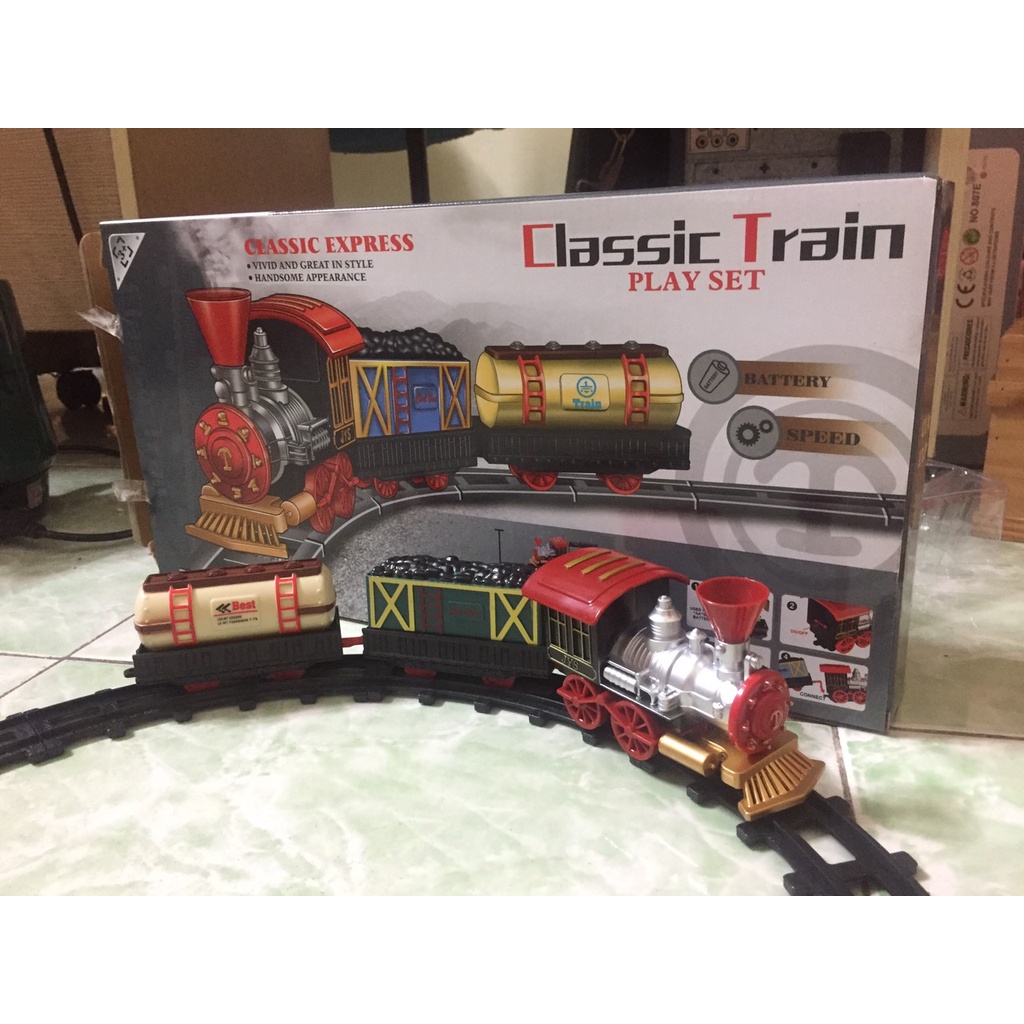 Đồ chơi đường ray xe lửa ben màu xanh có đầu tàu và 2 toa ,2 cây thông màu xanh, các đường ray