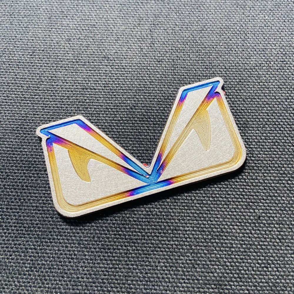 TEM trang trí xe máy HOẠT HÌNH MẮT CÚ chất liệu TITANNIUM