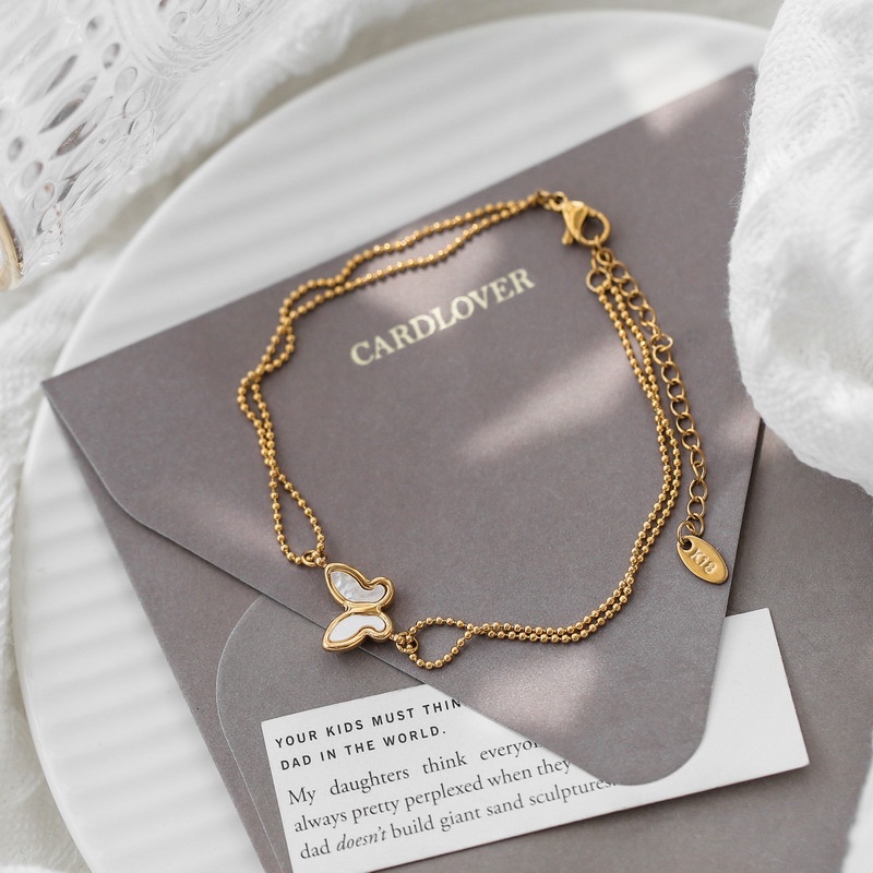 Lắc chân titan dây bi phối mặt hình bướm cẩm xà cừ không gỉ