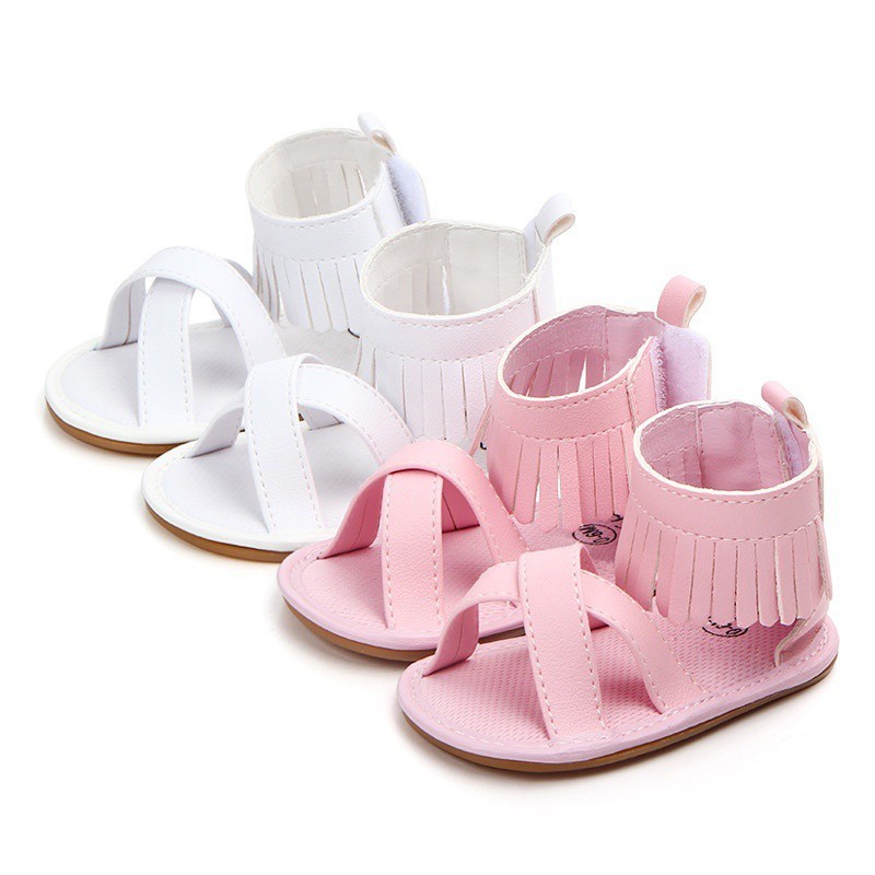 Giày sandal da PU màu trơn quai đan chéo phối tua rua đáng yêu cho bé gái