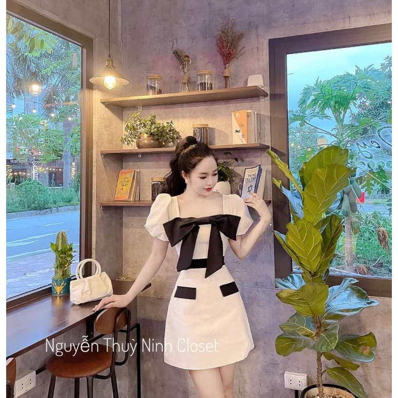 Đầm khoét cổ đính nơ hở lưng tiểu thư