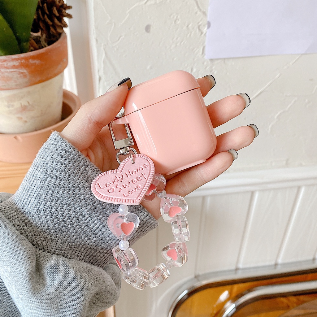 Vỏ bảo vệ hộp sạc tai nghe bluetooth airpods 1 / 2 bằng tpu mềm hình kẹo trái tim màu hồng có dây đeo chống thất lạc
