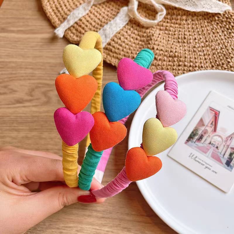 Bờm vải nhún trái tim cho bé gái
