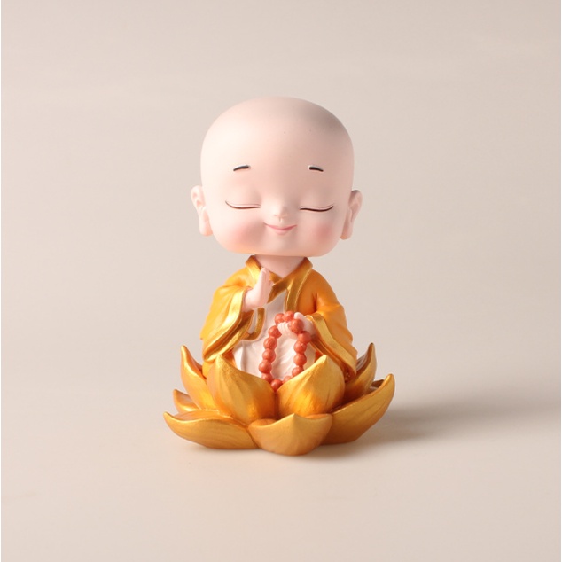 Tượng chú tiểu ngồi đài sen, lá sen bình an ngộ nghĩnh