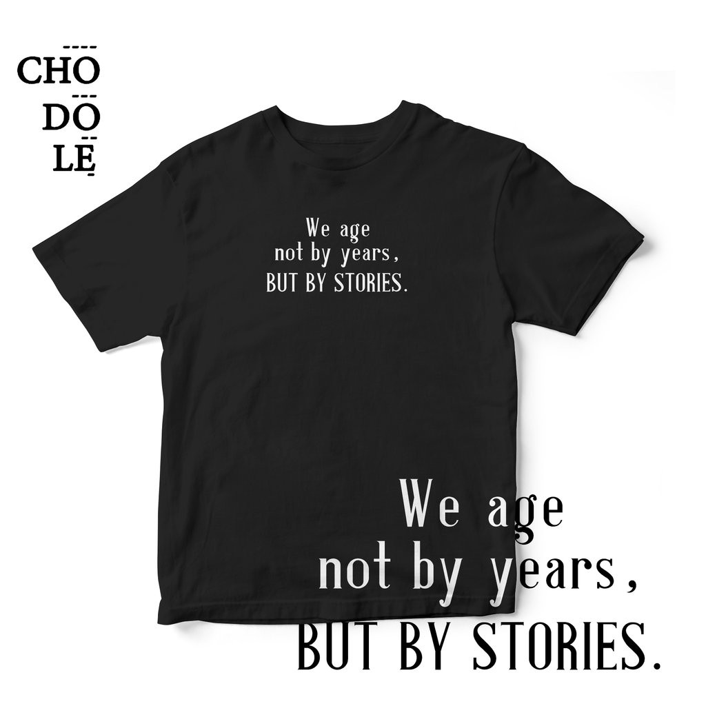 Áo thun unisex cotton 100%  in chữ WE AGE NOT BY YEARS, BUT BY STORIES (nhiều màu)