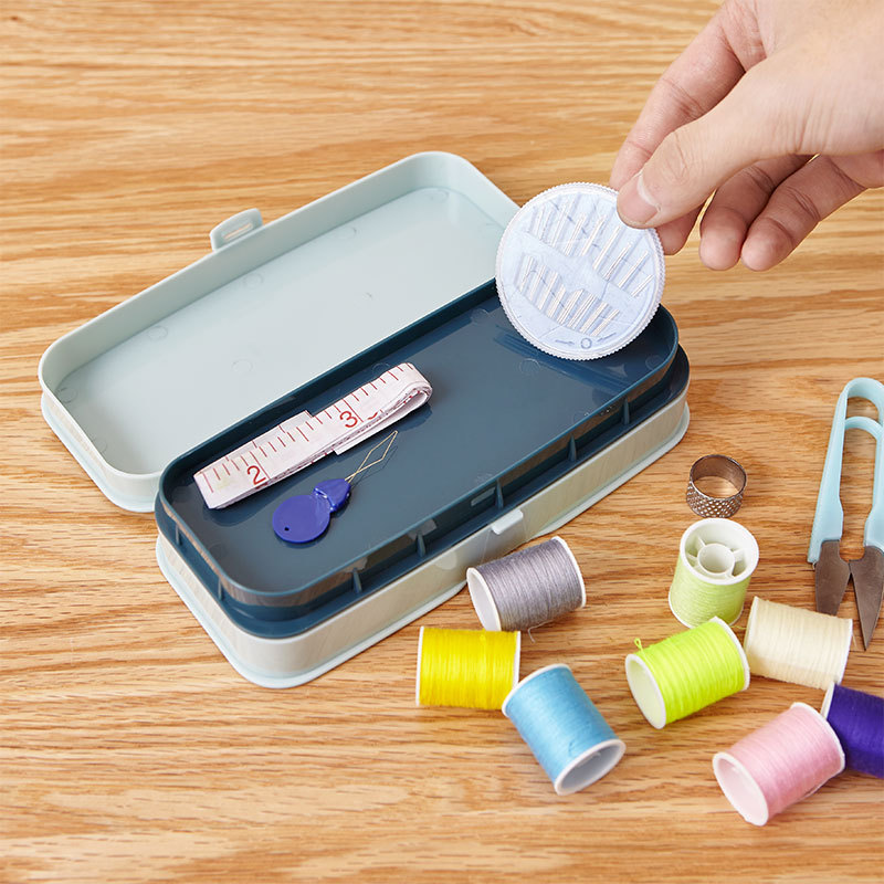 A box of needle and thread combination hand-held double-layer sewing with lock with tape measure and linen kit.