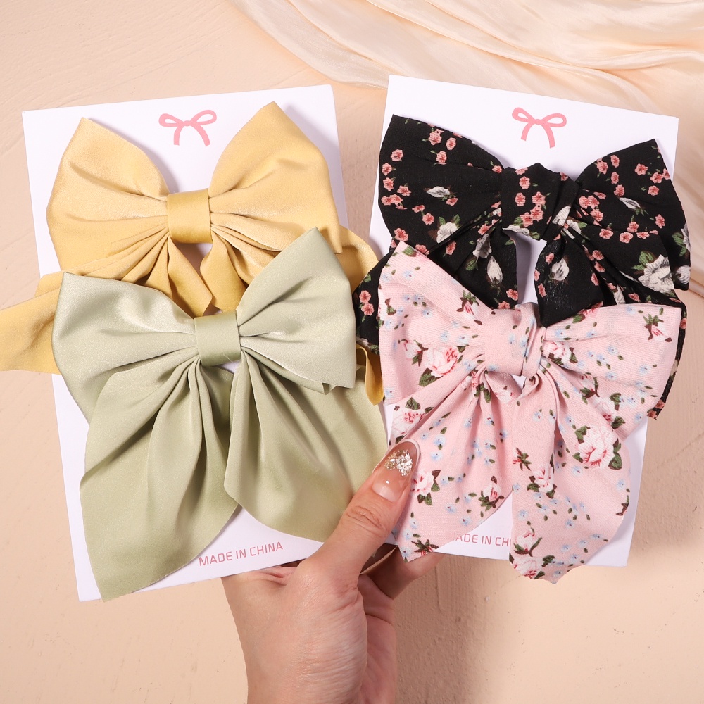 Set 2 kẹp tóc KIDSBOWS hình nơ họa tiết hoa xinh xắn dành cho nữ