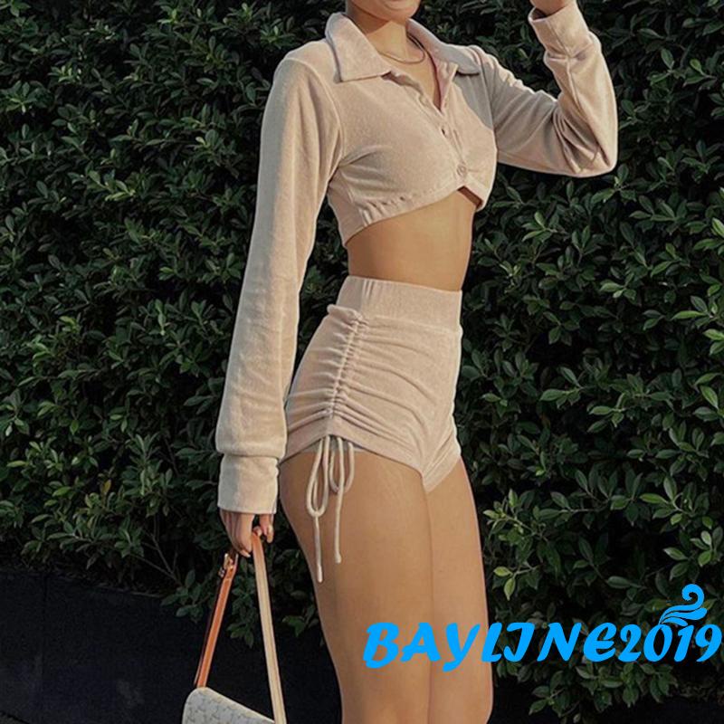 Bộ đồ hai mảnh gồm áo cổ gài nút dài tay và quần đùi cạp cao có dây rút xếp nếp mặc thường ngày cho nữ