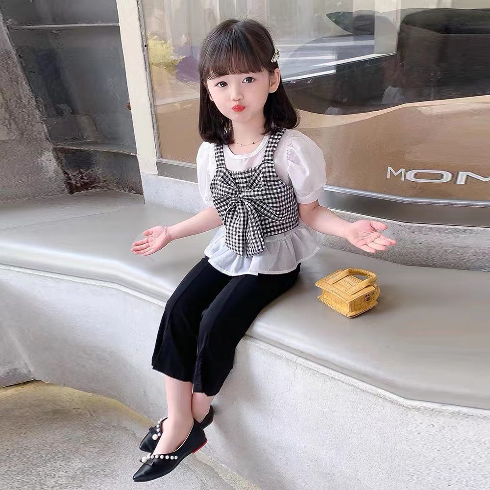 Xả hàng_Bộ bé gái áo nơ kẻ caro đen trắng và quần loe gấu 10-30kg XHN935