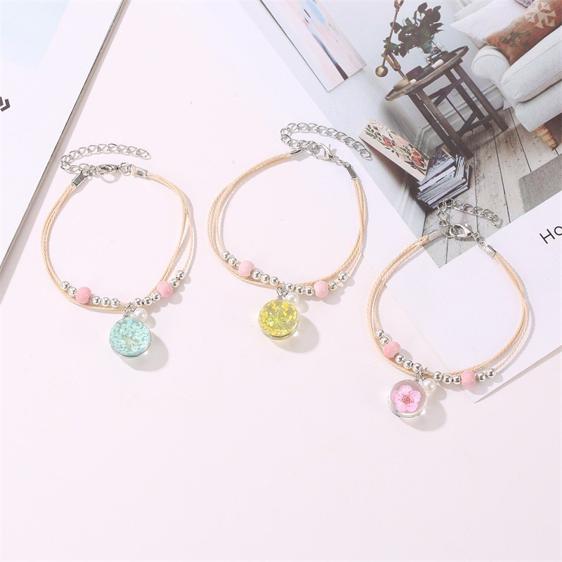 The aqua sphere shaped accessory bracelet contains lovely Korean style dried flowers