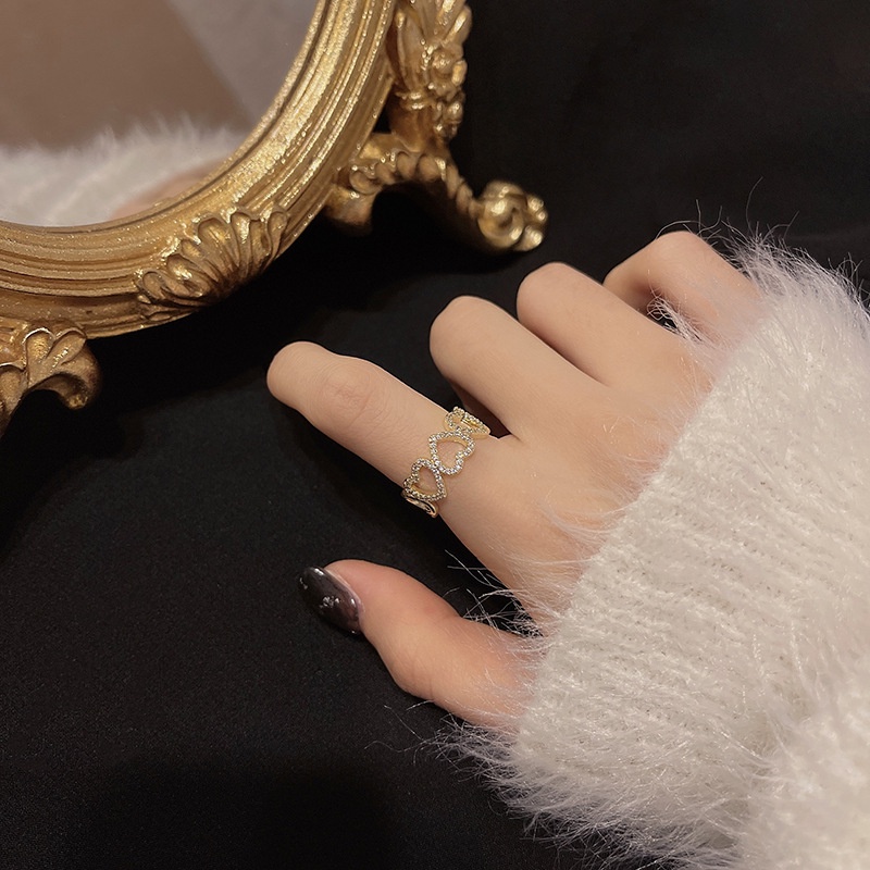 Elegant open-cut heart-shaped ring with zircon stones for women