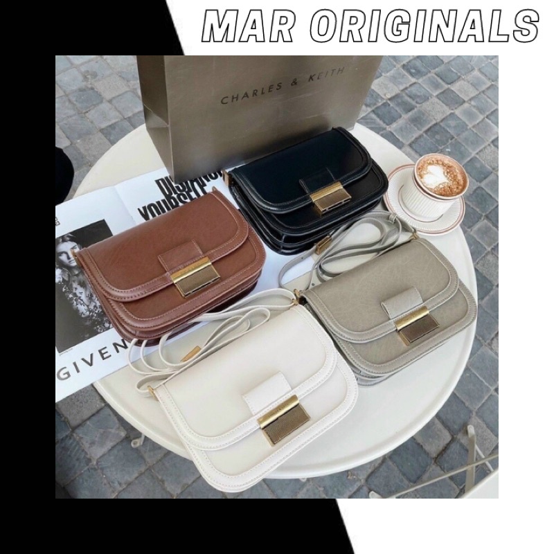 Túi xách nữ đeo chéo Charles and Keith dáng bầu chữ nhật dây bản nhỏ size 21cm