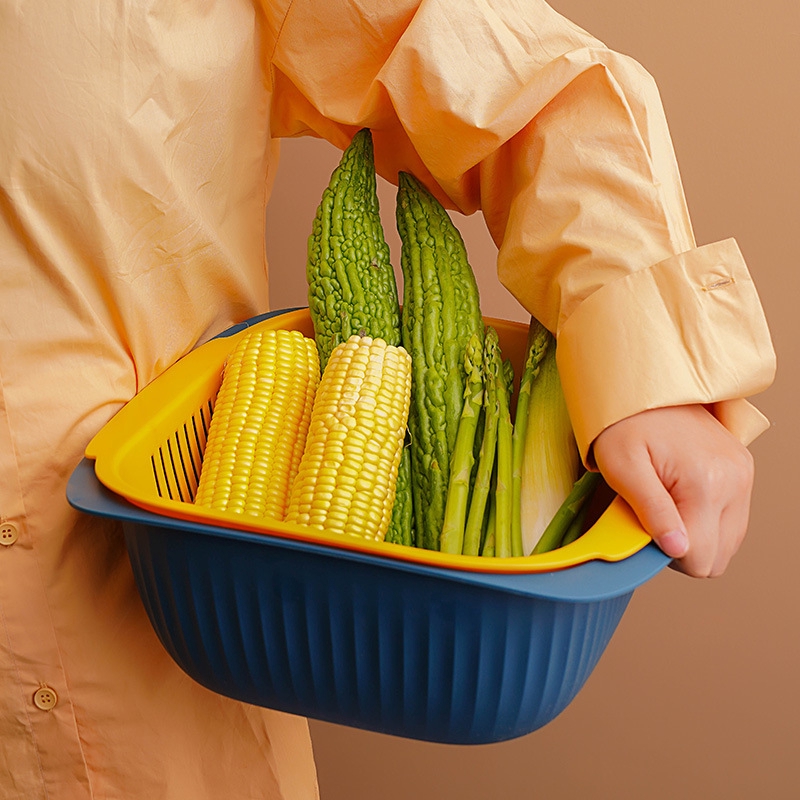 The plastic double-layer vegetable washing basket is a multifunctional fruit drain basket for household kitchens.