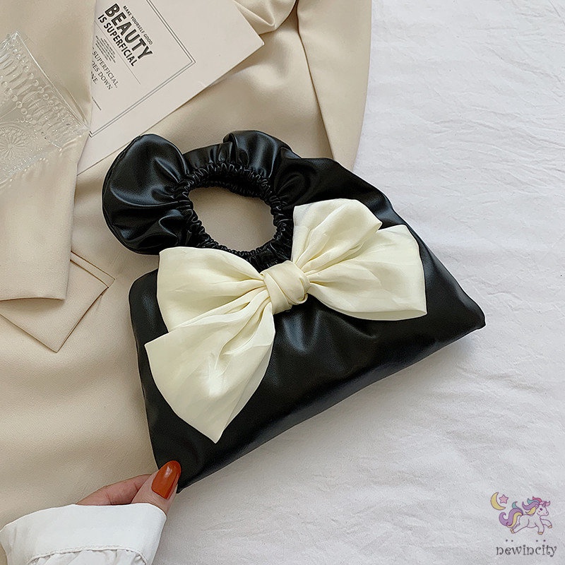 Túi xách cầm tay thiết kế xếp nếp gắn nơ thời trang Hàn Quốc cho trẻ em - người lớn