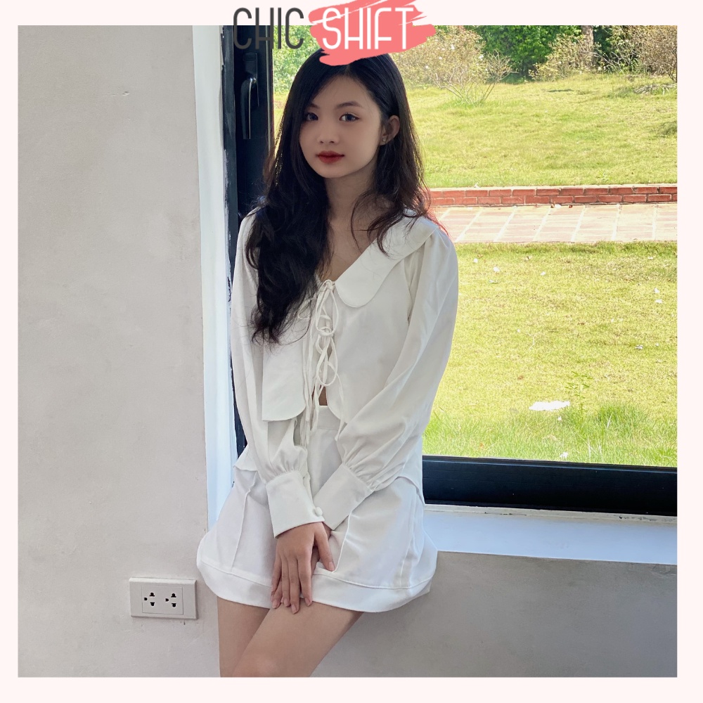 Áo sơmi nữ dài tay cột nơ cách điệu màu đen và trắng vạt áo lượn sóng mặc đi học, đi chơi - Chicshift