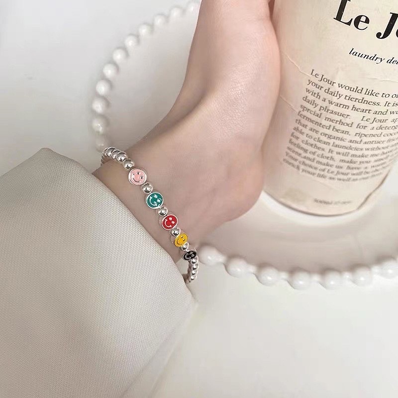 Vòng tay dây cước charm mặt cười-hoa cúc