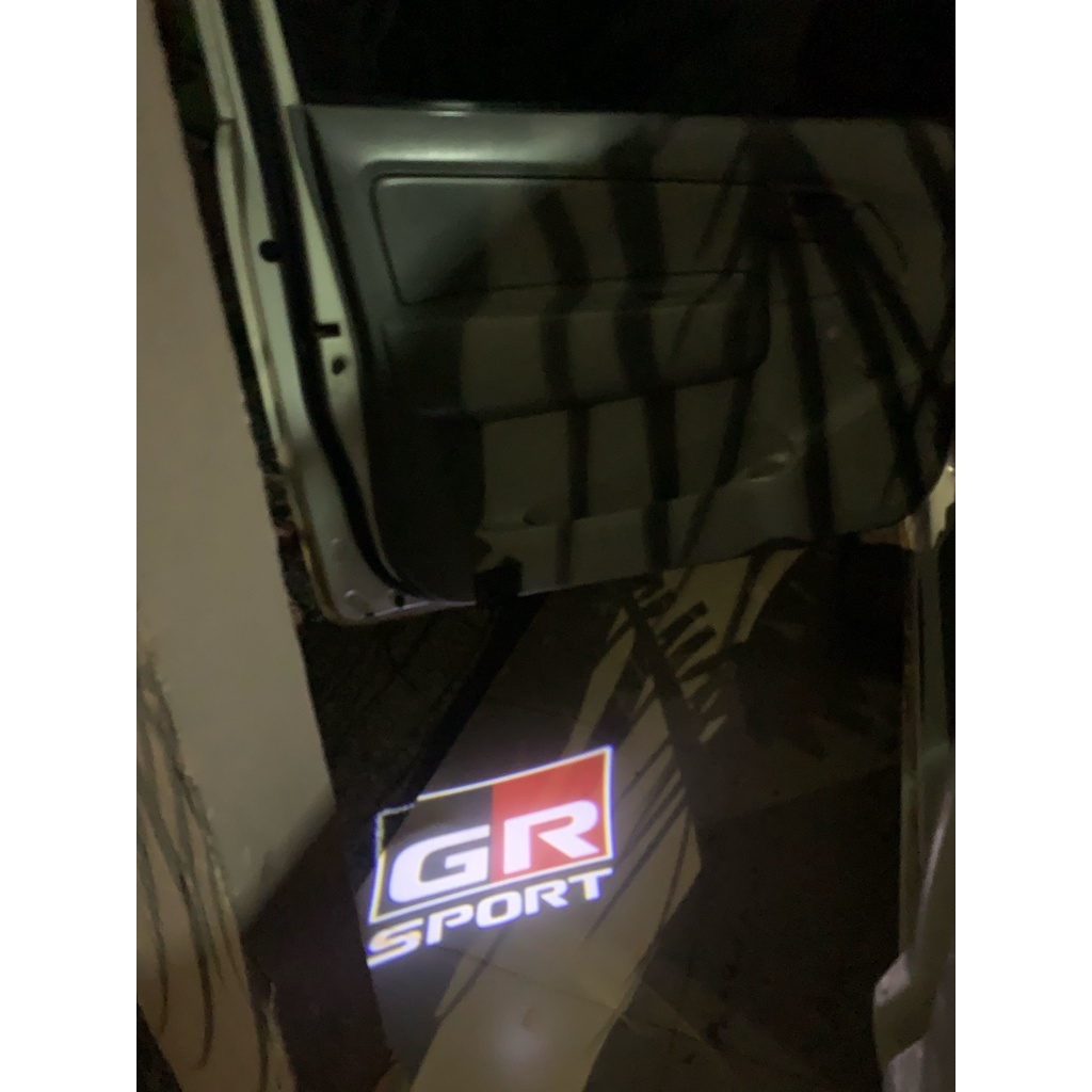 2 Đèn LED Chiếu Sáng Cửa Xe Hơi Cho Toyota GR VIos Yaris Corolla Cross Wish Revo CHR Avanza Fortuner Rush Wigo Innova