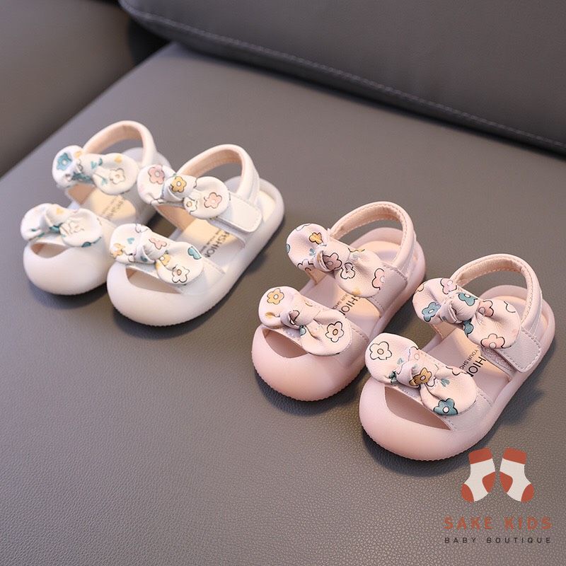 Sandal tập đi chống vấp phối nơ hình Bông hoa mũi có đế chống trơn trượt kiểu dáng Hàn Quốc mới nhất M865