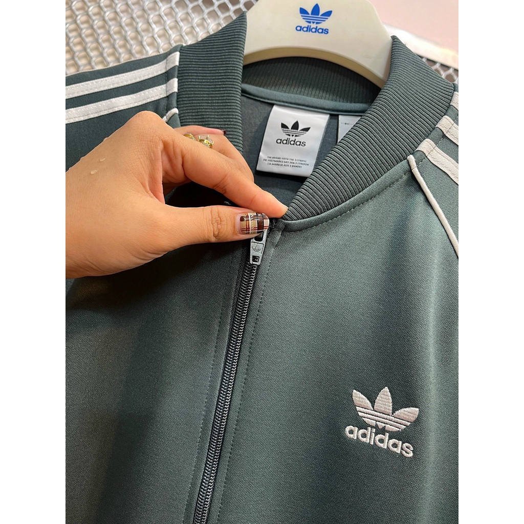 Bộ Quần Áo Thể Thao Unisex Nam Nữ Adidas SST Track Màu Xi Măng