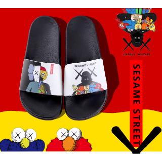 Dép quai ngang mang trong nhà in hình Kaws thời trang UNISEX