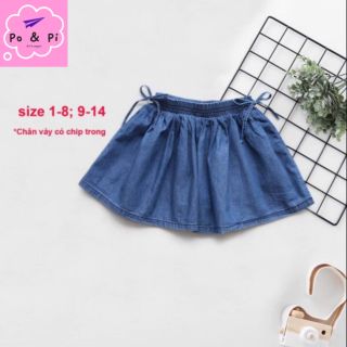 Chân váy jean xoè( vải bò giấy, có chip) đính nơ 2 bên.