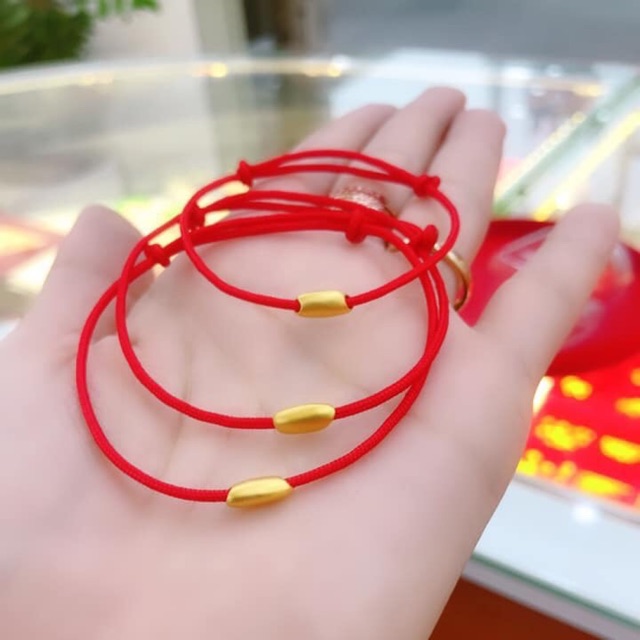 Vòng tay chỉ đỏ tết charm hạt gạo may mắn