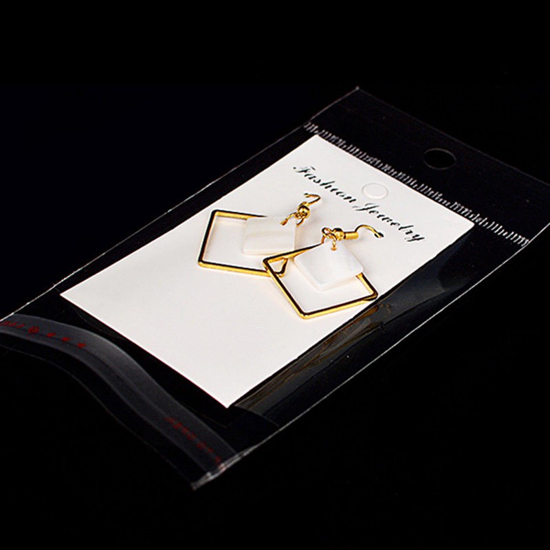 Set 100 túi tự dính và thẻ giấy màu trắng đựng trưng bày trang sức