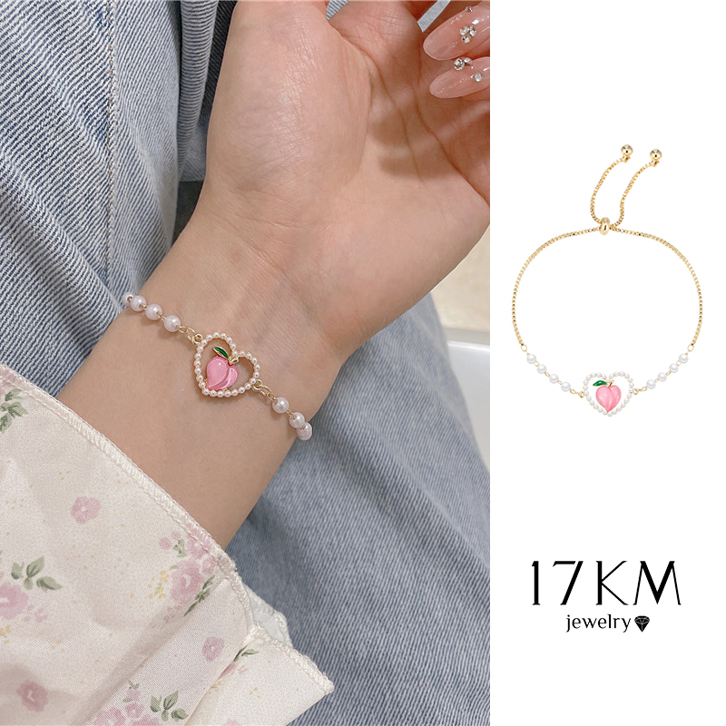 Vòng tay 17KM chuỗi hạt ngọc trai mặt trái tim rỗng màu hồng thời trang Hàn Quốc cho nữ
