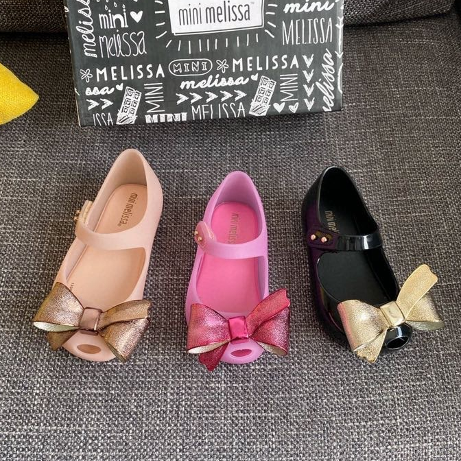 Mini Melissa Xăng đan Nhựa Hở Mũi Đính Nơ Mạ Vàng Mới Cho Bé Gái