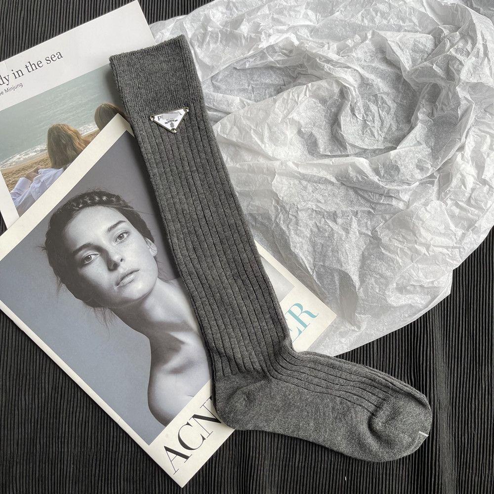 Prada triangular letter mid-length double-needle wide strip trendy brand stockings pure color luxury high-value women s