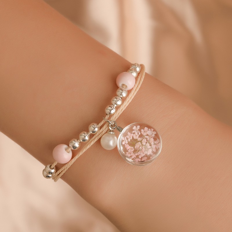 The aqua sphere shaped accessory bracelet contains lovely Korean style dried flowers